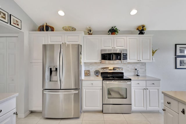 kitchen with white cabinetry, appliances with stainless steel finishes, and light tile patterned floors