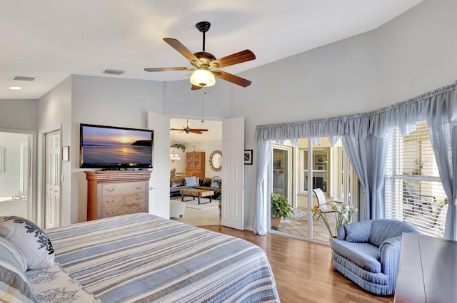 bedroom featuring lofted ceiling, light hardwood / wood-style floors, and ceiling fan