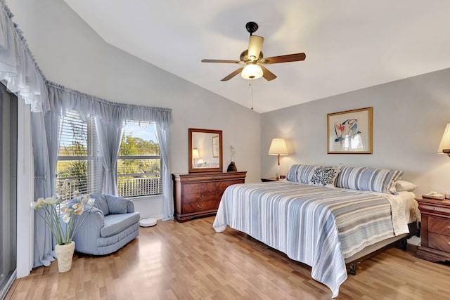 bedroom with hardwood / wood-style flooring, vaulted ceiling, and ceiling fan