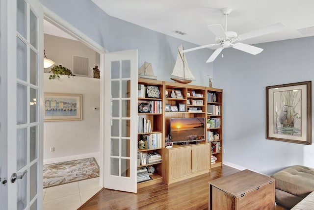 living area featuring french doors, ceiling fan, and hardwood / wood-style flooring