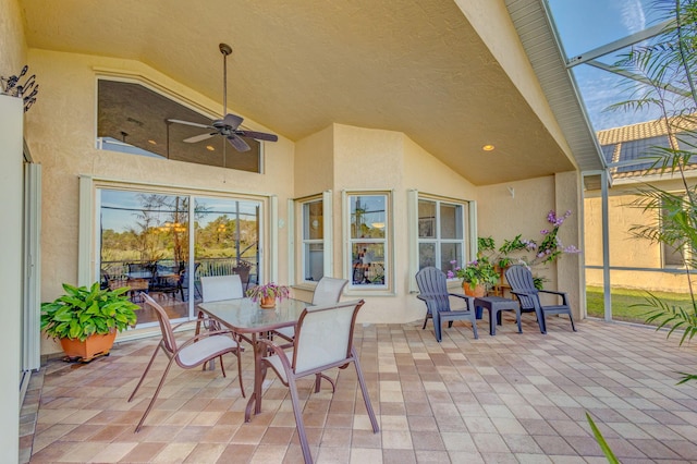 view of patio featuring ceiling fan and a lanai