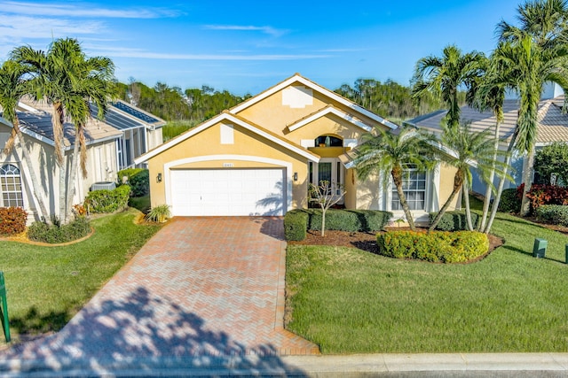 view of front of property featuring a garage and a front lawn