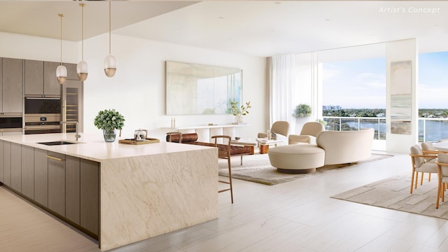 kitchen with a water view, sink, a kitchen island with sink, and dark brown cabinets