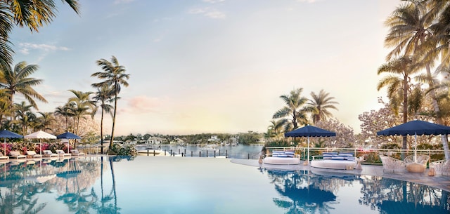 pool at dusk with a water view