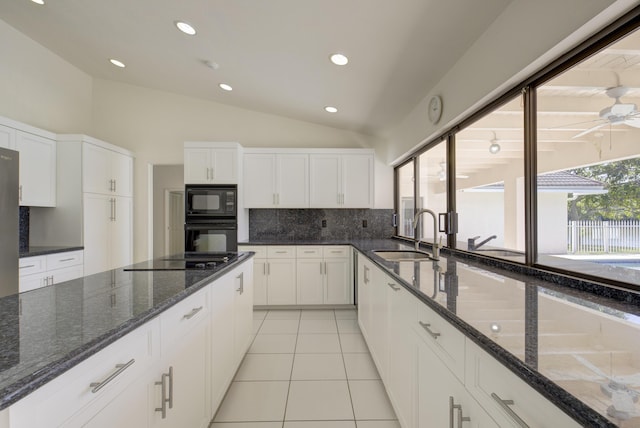 kitchen featuring white cabinetry, sink, black appliances, and dark stone countertops