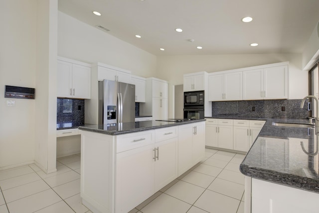 kitchen featuring white cabinetry, a center island, sink, and black appliances