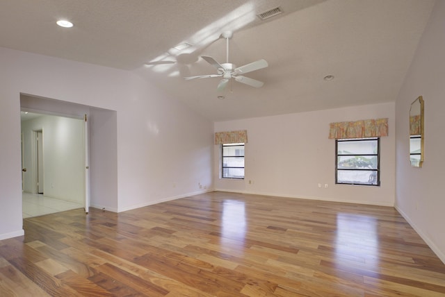 unfurnished room with ceiling fan, lofted ceiling, and light hardwood / wood-style floors