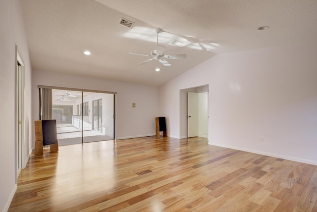 unfurnished room with vaulted ceiling, a textured ceiling, ceiling fan, and light hardwood / wood-style floors