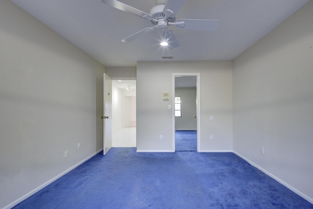 unfurnished bedroom featuring ceiling fan and dark carpet