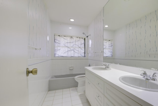 bathroom featuring vanity, tile walls, tile patterned floors, and toilet