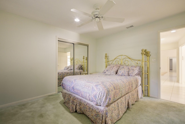 bedroom with a closet, ceiling fan, and carpet flooring