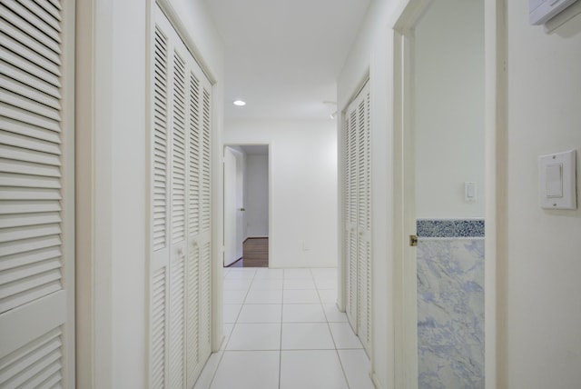 corridor featuring light tile patterned floors