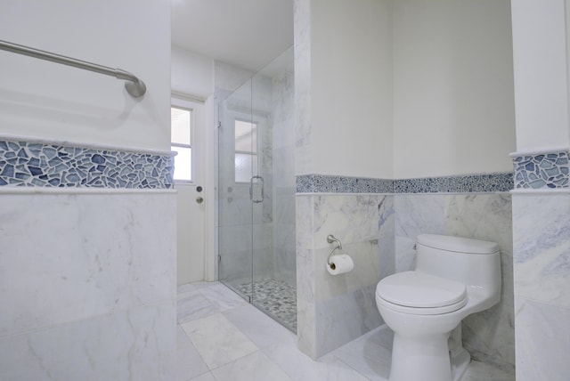 bathroom featuring toilet, an enclosed shower, tile patterned flooring, and tile walls