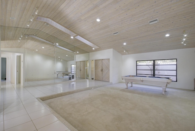 interior space with light tile patterned floors, pool table, wooden ceiling, and high vaulted ceiling