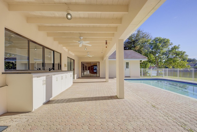 view of swimming pool with ceiling fan and a patio area