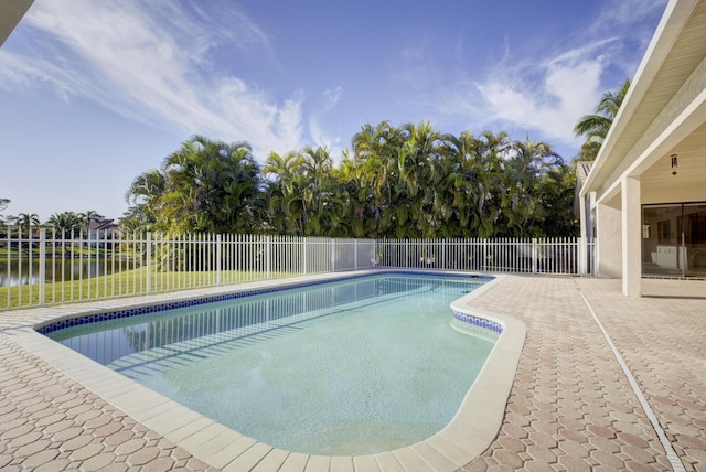 view of pool with a water view and a patio area