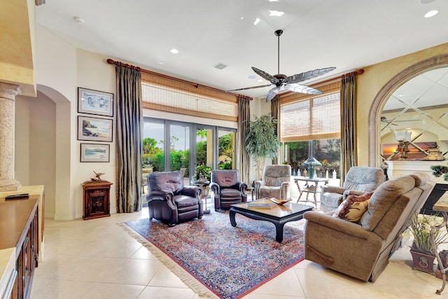 tiled living room featuring a high ceiling and ceiling fan