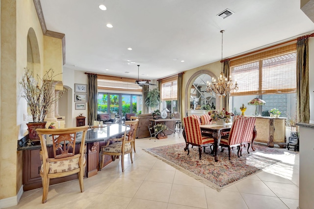 tiled dining area with ceiling fan with notable chandelier