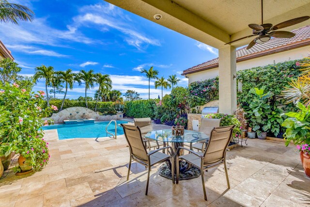 view of patio / terrace featuring area for grilling, french doors, ceiling fan, and an outdoor kitchen