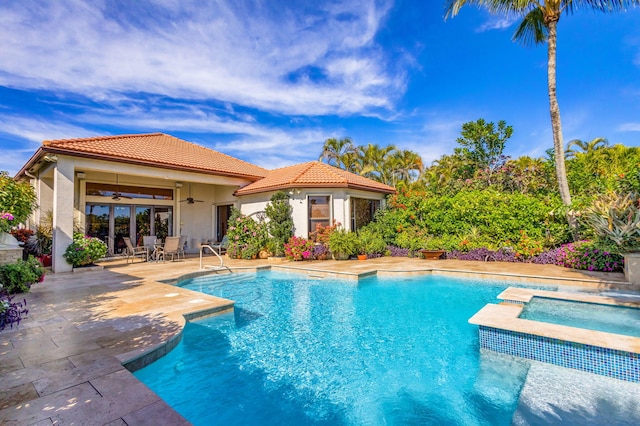 view of pool featuring french doors, an in ground hot tub, ceiling fan, and a patio area