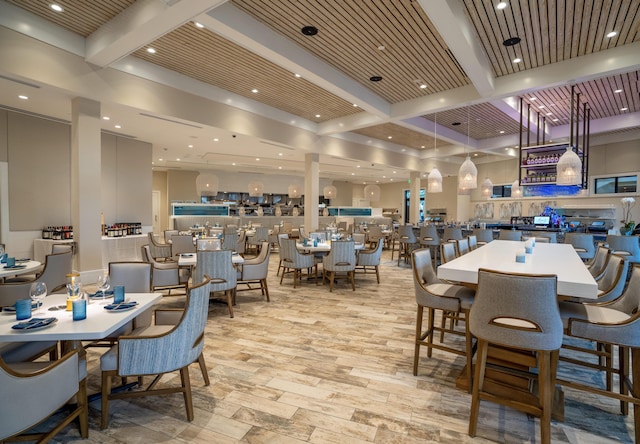 dining space with beamed ceiling and wood ceiling