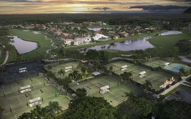 aerial view at dusk featuring a water view