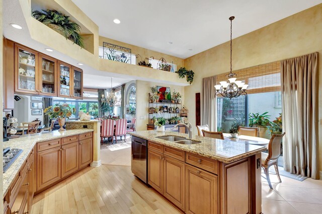 dining room with an inviting chandelier, a towering ceiling, and light tile patterned flooring