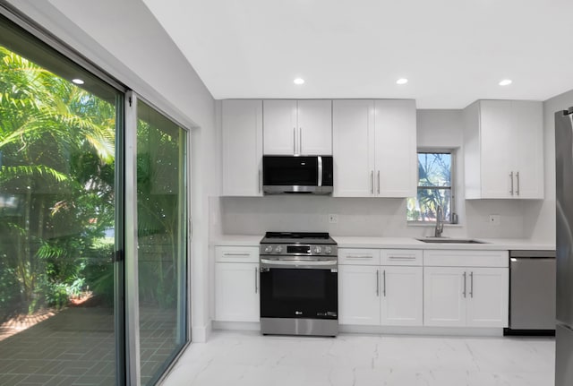 kitchen featuring white cabinetry, appliances with stainless steel finishes, and sink