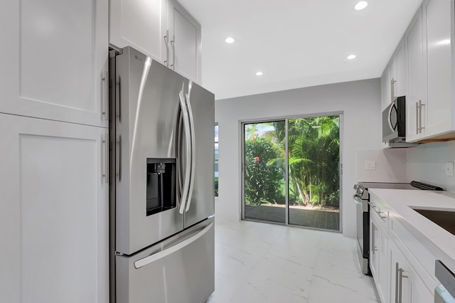 kitchen with appliances with stainless steel finishes and white cabinets