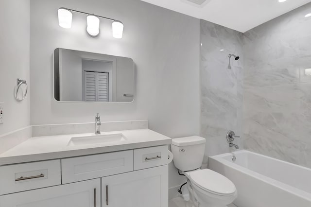 full bathroom with tiled shower / bath combo, vanity, and toilet