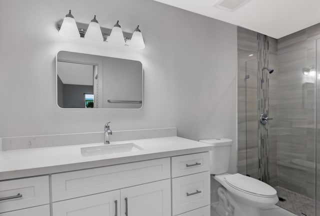 bathroom with vanity, an enclosed shower, and toilet