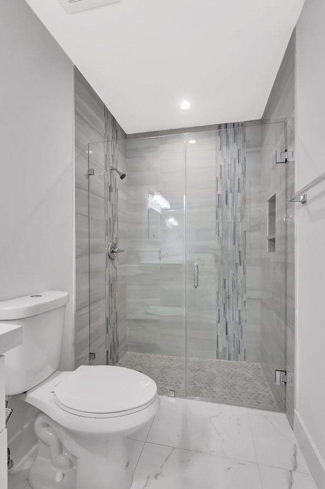 bathroom featuring toilet and walk in shower