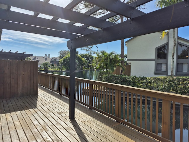 wooden terrace featuring a pergola and a water view