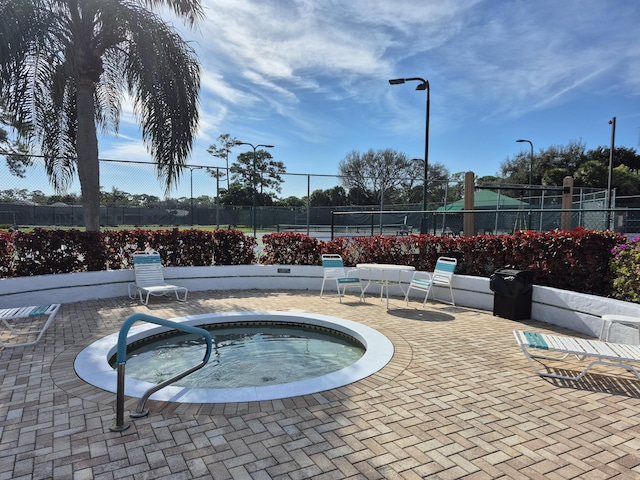 view of pool featuring a community hot tub and a patio