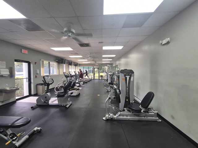 workout area with a drop ceiling and ceiling fan