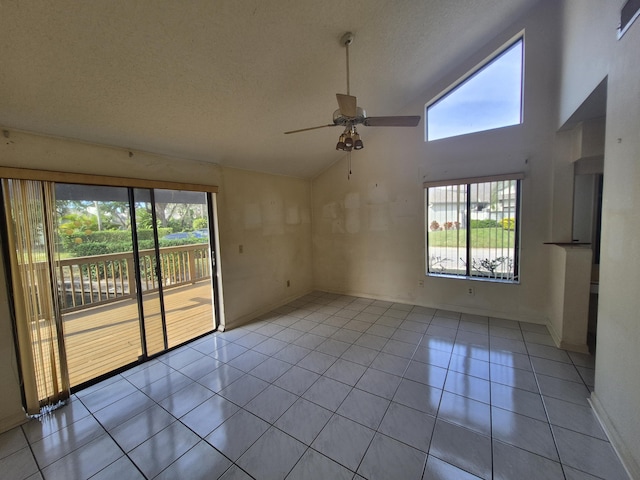 tiled empty room with a textured ceiling, high vaulted ceiling, and ceiling fan