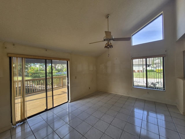 tiled spare room featuring ceiling fan, lofted ceiling, and a textured ceiling