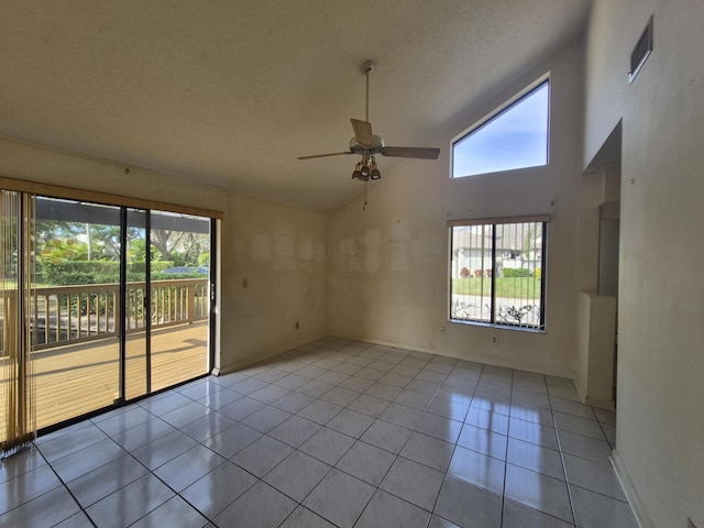 spare room featuring light tile patterned flooring, high vaulted ceiling, a textured ceiling, and ceiling fan