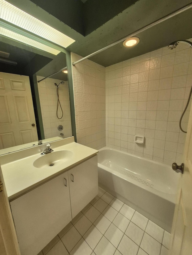 bathroom featuring tile patterned floors, tiled shower / bath combo, and vanity