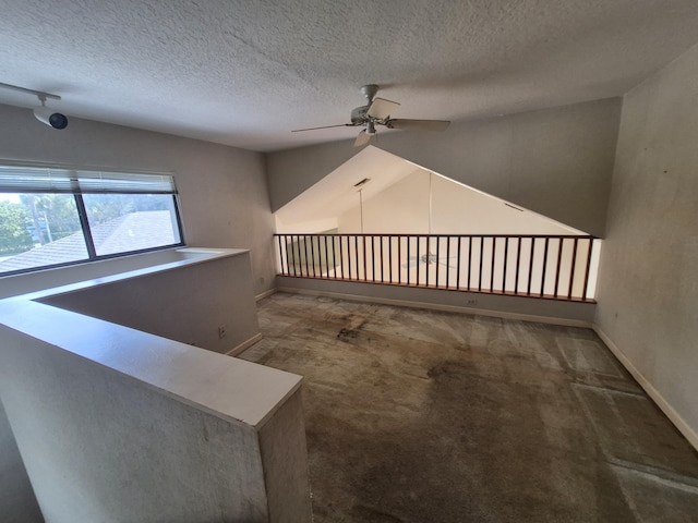 stairs with vaulted ceiling, ceiling fan, carpet, and a textured ceiling