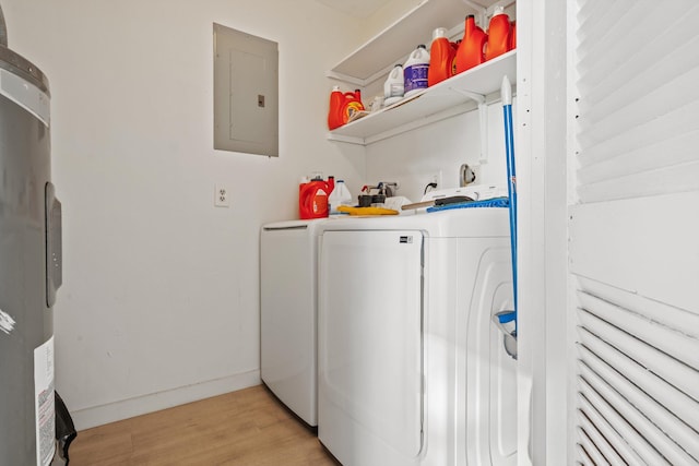 laundry area featuring water heater, light hardwood / wood-style floors, electric panel, and washer and dryer