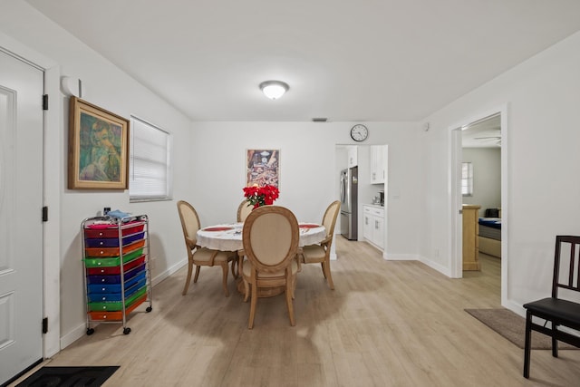 dining space with light hardwood / wood-style floors