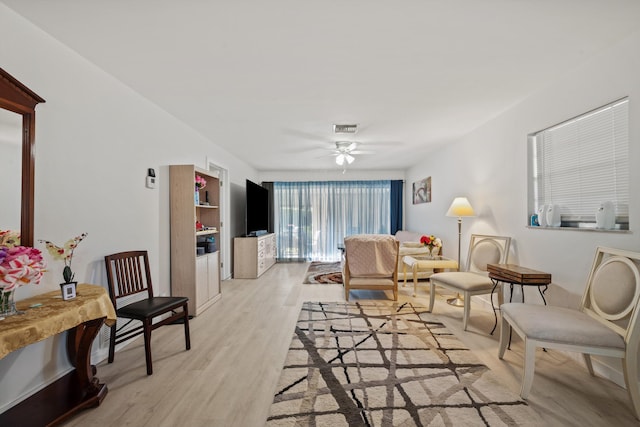 living room with ceiling fan and light wood-type flooring