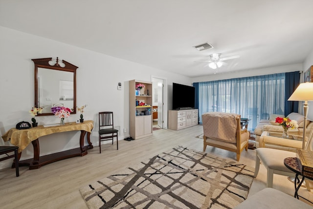 living room featuring ceiling fan and light wood-type flooring