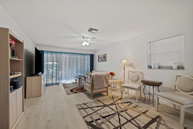 living room featuring ceiling fan and light wood-type flooring