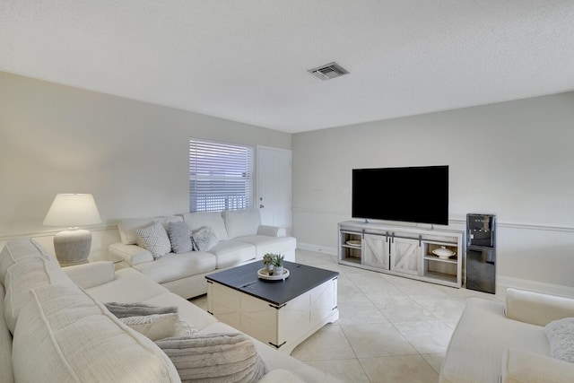 tiled living room with a textured ceiling