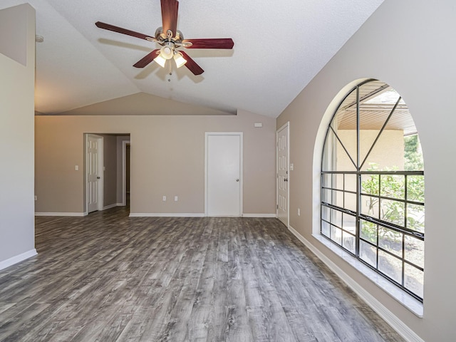 unfurnished room with wood-type flooring, vaulted ceiling, and ceiling fan