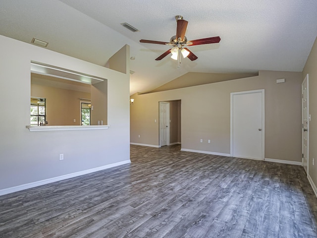 unfurnished room with hardwood / wood-style floors, a textured ceiling, vaulted ceiling, and ceiling fan