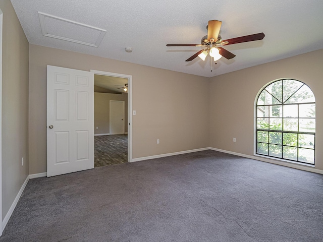 carpeted empty room with a textured ceiling