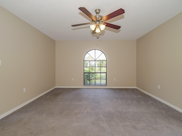 empty room featuring light carpet, ceiling fan, and a textured ceiling